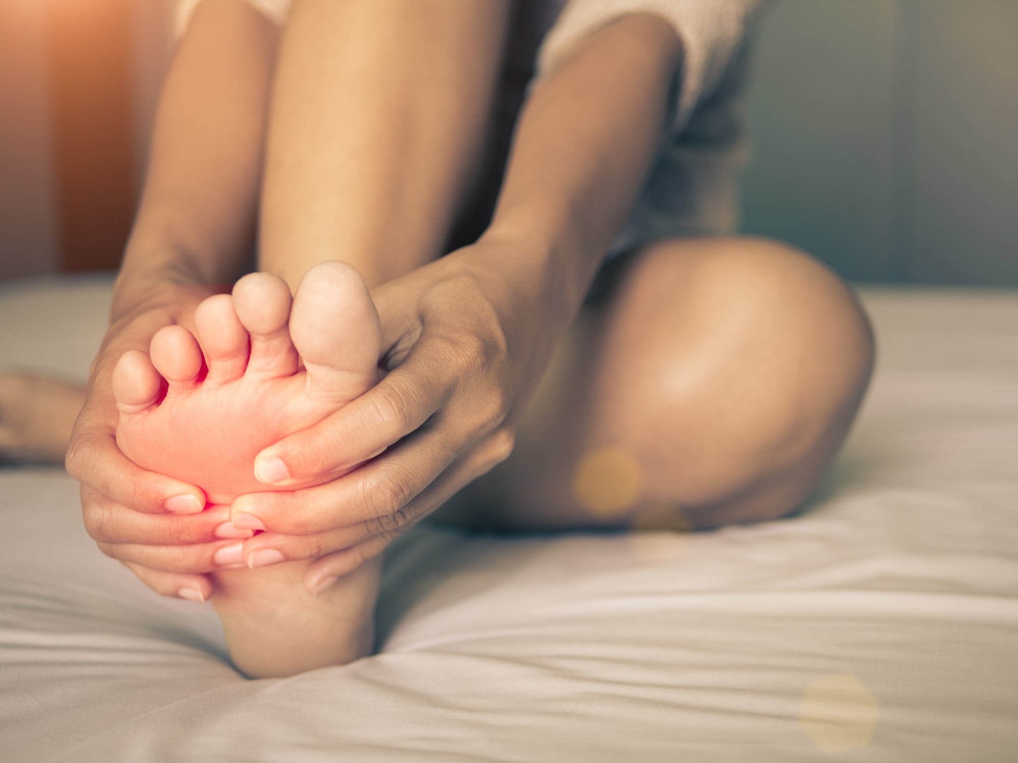 person holding foot in pain